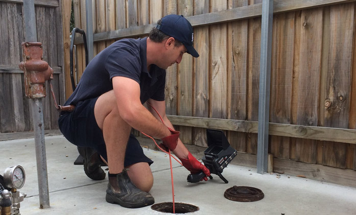 Plumber attending a blocked drain callout in Dandenong